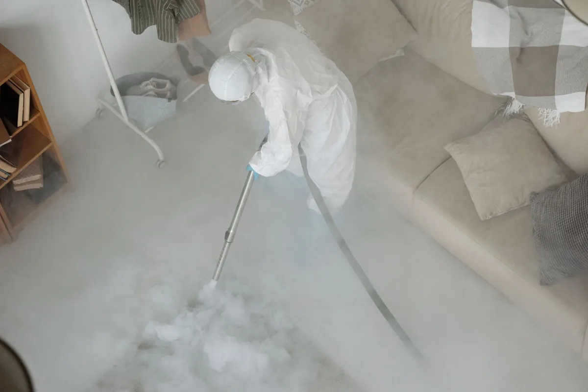 Biohazard cleanup technician in protective equipment, Flemington, PA